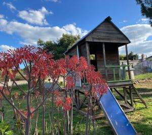 a playground with a slide next to a house at Apto en Minas con amplio fondo, aire acondicionado, ideal para descansar in Minas