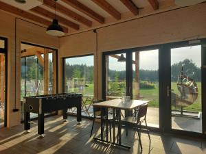 a screened in porch with a pool table and a piano at Moje Miejsce Jura in Lgota Murowana