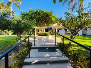 a set of stairs leading to a house with trees at Casa en Real del Country in Manzanillo