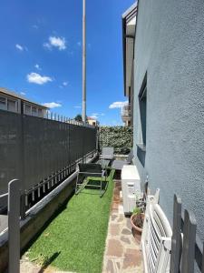 a patio with chairs and grass on a building at Villa Girasole in Cesano Maderno