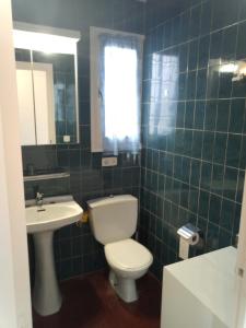a bathroom with a toilet and a sink at Artmony piso centro del pueblo vista frente al mar appartement plein centre en front de mer in Port de la Selva