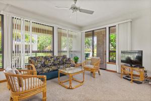 a living room with a couch and a tv at Shores at Waikoloa 112 - MCH in Waikoloa