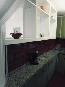 um balcão de cozinha com um lavatório e um espelho em Artmony piso centro del pueblo vista frente al mar appartement plein centre en front de mer em Port de la Selva