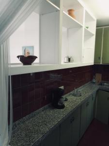 a kitchen counter with a sink and a mirror at Artmony piso centro del pueblo vista frente al mar appartement plein centre en front de mer in Port de la Selva