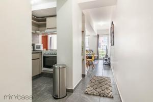 a kitchen and dining room with white walls at Stylish and modern Apt. with private balcony in Mexico City