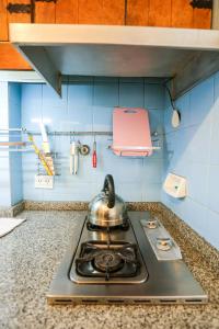a kitchen stove with a tea kettle on top of it at Center Bariloche in San Carlos de Bariloche