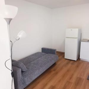 a living room with a couch and a refrigerator at Casa Bela Vista Studio 1 in Ribeira Brava