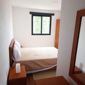 a small room with a bed and a window at Casa Bela Vista Studio 1 in Ribeira Brava