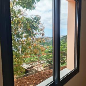 a window with a view of a city at Casa Bela Vista Studio 1 in Ribeira Brava