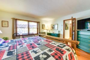 a bedroom with a large bed and a kitchen at Villa lAbri BBQ-Ready Maggie Valley Escape! in Maggie Valley