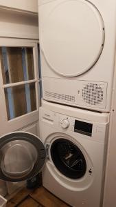 a washing machine in a room with a window at Au Cœur de la Verrière du Château Burrus in Sainte-Croix-aux-Mines