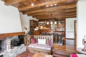 a living room with a fireplace and a dining room at Casa Aran by Totiaran in Naut Aran