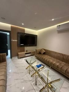 a living room with a couch and a tv at وناسه مودرن in Riyadh