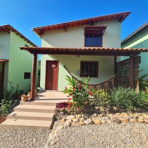a house with a pathway leading to the front door at Green Chales - Vale do Capão in Vale do Capao