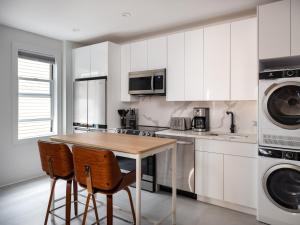 a kitchen with a wooden table and two chairs at Three Bedroom Brooklynite Suite! in Brooklyn