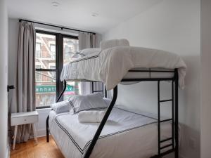 a bedroom with a bunk bed and a window at Three Bedroom Brooklynite Suite! in Brooklyn