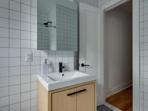 a bathroom with a sink and a mirror at Three Bedroom Brooklynite Suite! in Brooklyn