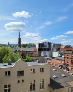 a view of a city with buildings and a church at Ottimo Apartamenty Jagiellońska in Bydgoszcz
