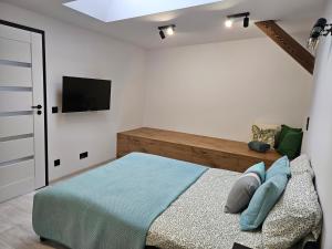 Łóżko lub łóżka w pokoju w obiekcie Ottimo Apartamenty Jagiellońska