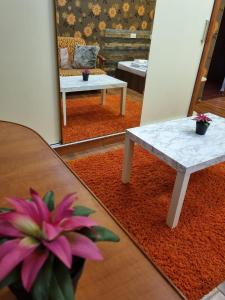 a living room with a table and a pink flower at My house studio in Bucharest