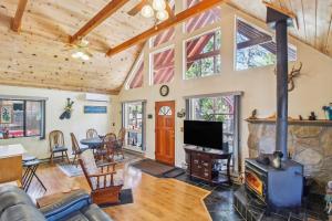 a living room with a fireplace and a tv at Peaceful Pinetop-Lakeside Cabin with 4 Decks! in Pinetop-Lakeside