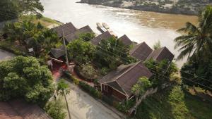 an aerial view of a house next to a river at Mekong Riverside Lodge in Pakbeng