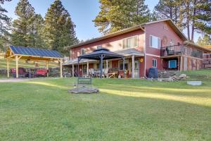 a large house with a lawn in front of it at Hills City Hideaway 12 Miles to Mt Rushmore! in Hill City