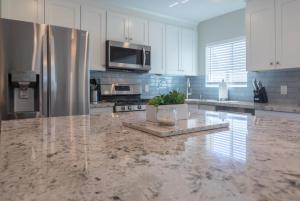 a kitchen with a marble counter top and stainless steel appliances at Modern Arcadia Lite Oasis Pool Heater BBQ in Phoenix