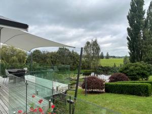 a glass house with a view of a garden at Hobbiton Countryside Sanctuary in Matamata