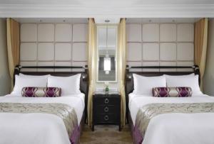 a hotel room with two beds and a mirror at The Venetian® Resort Las Vegas in Las Vegas