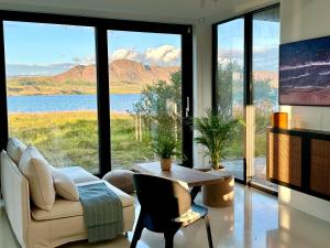 sala de estar con sofá y mesa en The Oceanfront Private northern lights villa., en Reynivellir