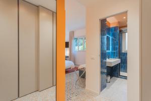 a bathroom with a sink and a room with a mirror at Marcello's Como Lake in Como