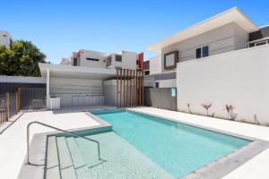 a swimming pool in the backyard of a house at Casa Allura in Coolum Beach