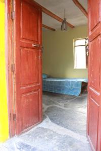 una porta aperta per una camera con un letto in esso di Albergue Esmeralda - Camping a Sorata