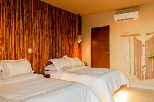 a bedroom with two beds and a window at Hotel Scappata in Progreso