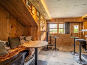 a room with a bed and a table and stools at Fernblick in Kirchberg in Tirol