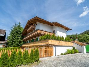 a house with a wooden fence in front of it at Fernblick in Kirchberg in Tirol