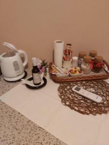 a counter top with a tray of food and a remote control at Apartments Ant in Budva