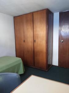 a room with a closet and a bed and a cabinet at Patio Urbano Suites & beds in Montevideo