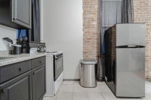 a kitchen with a refrigerator and a trash can at Apartment 253: Chelsea in New York