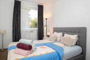 1 dormitorio con 2 camas con almohadas y ventana en Luxury Apartment Res, en Liubliana
