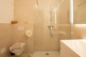 a bathroom with a shower and a toilet and a sink at Luxury Apartment Res in Ljubljana