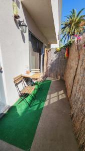 a patio with a table and chairs next to a wall at Cozy Private Room & Bath Central Location LA in Los Angeles
