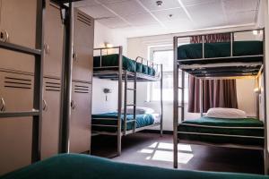 a room with two bunk beds and a window at YHA Adelaide Central in Adelaide