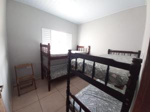 two bunk beds in a room with a window at Residência in Caraguatatuba