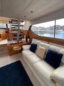 a living room on a boat with a couch at SUPERYACHT ON 5 STAR OCEAN VILLAGE MARINA, SOUTHAMPTON - minutes away from city centre and cruise terminals - free parking included in Southampton