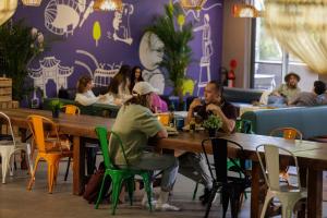 a group of people sitting at a table in a restaurant at YHA Adelaide Central in Adelaide