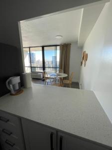 a kitchen with a counter top and a table with a view at Toronto Bachelor Midtown in Toronto