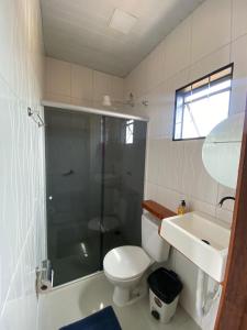 a bathroom with a shower and a toilet and a sink at POUSADA ORTEGA in Bodoquena