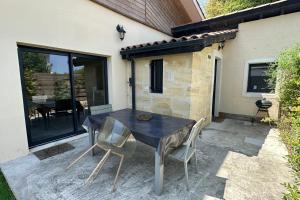 a black table and chairs on a patio at Cosy town house in Bordeaux stone in Villenave-dʼOrnon
